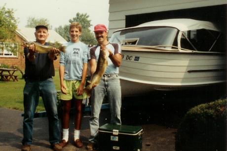 Grandpa Rz, Kris and Dad with the boat