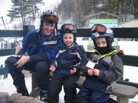 Andy and the kids take a ski break by the fire